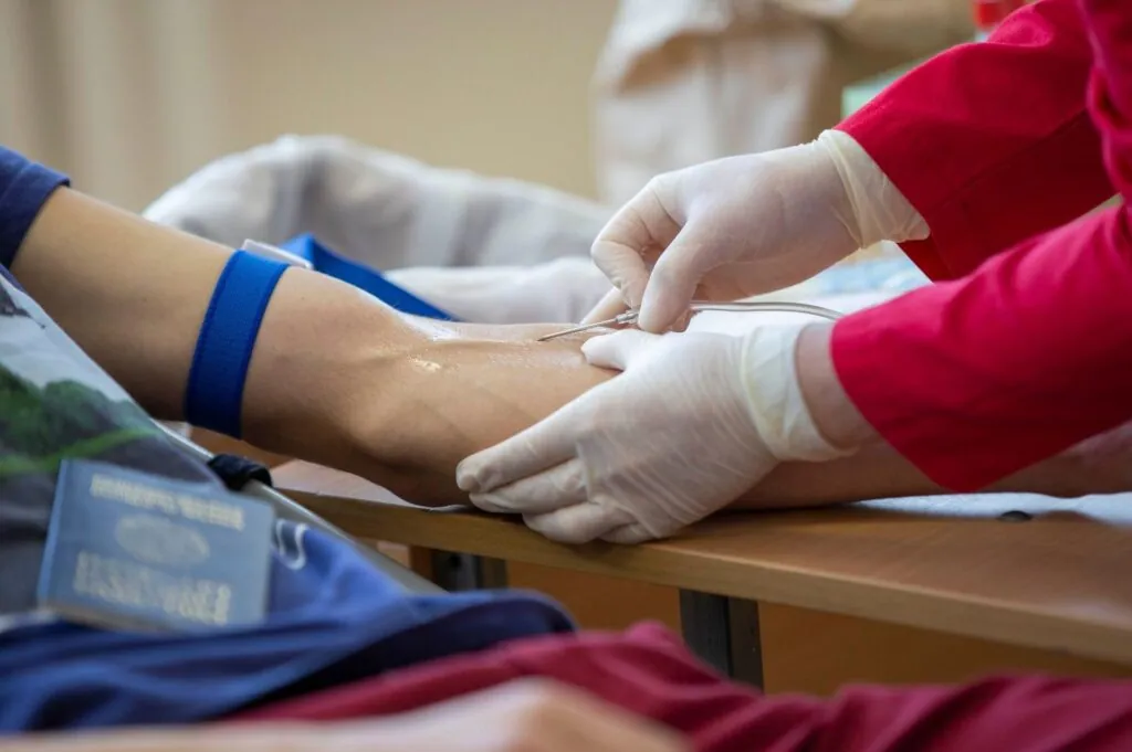 Healthcare professional administering NAD IV therapy near me in a clean clinic setting